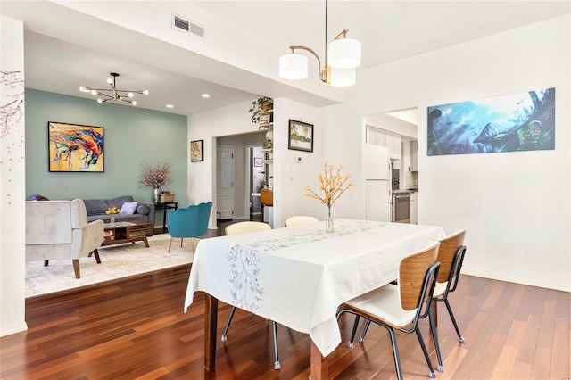 dining space with a chandelier, recessed lighting, visible vents, and dark wood-style floors