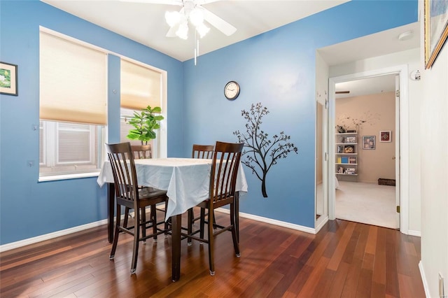 dining space with a ceiling fan, baseboards, and wood finished floors