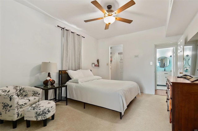 bedroom featuring light carpet and a ceiling fan