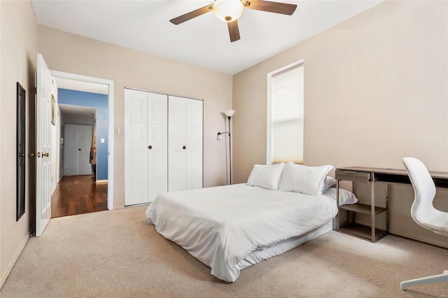 bedroom featuring ceiling fan, a closet, carpet, and baseboards