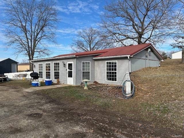 back of house with metal roof