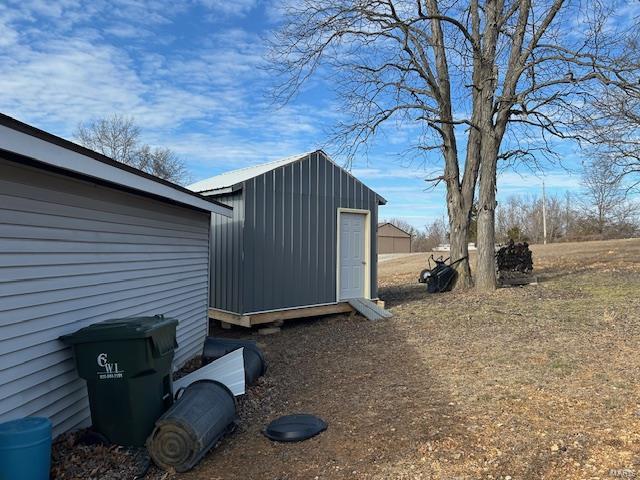 exterior space featuring a storage unit and an outbuilding