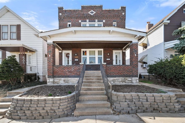 view of front of house with brick siding and covered porch