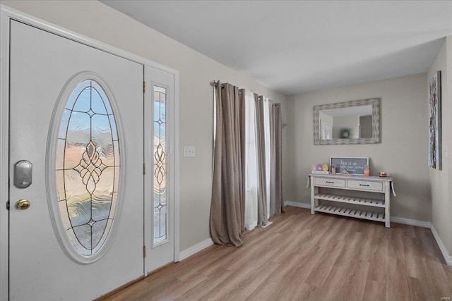 foyer featuring light wood-type flooring and baseboards