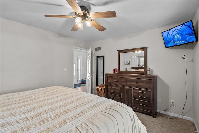 bedroom featuring light carpet, baseboards, visible vents, and ceiling fan