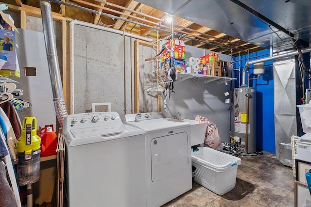 laundry area with gas water heater, washing machine and dryer, laundry area, a sink, and heating unit