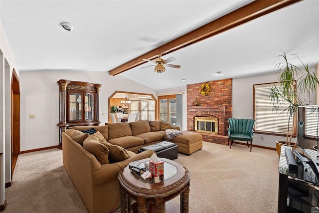 carpeted living room with ceiling fan with notable chandelier, a brick fireplace, vaulted ceiling with beams, and baseboards