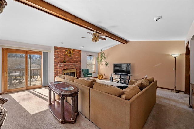 living room featuring a ceiling fan, baseboards, lofted ceiling with beams, a fireplace, and light colored carpet