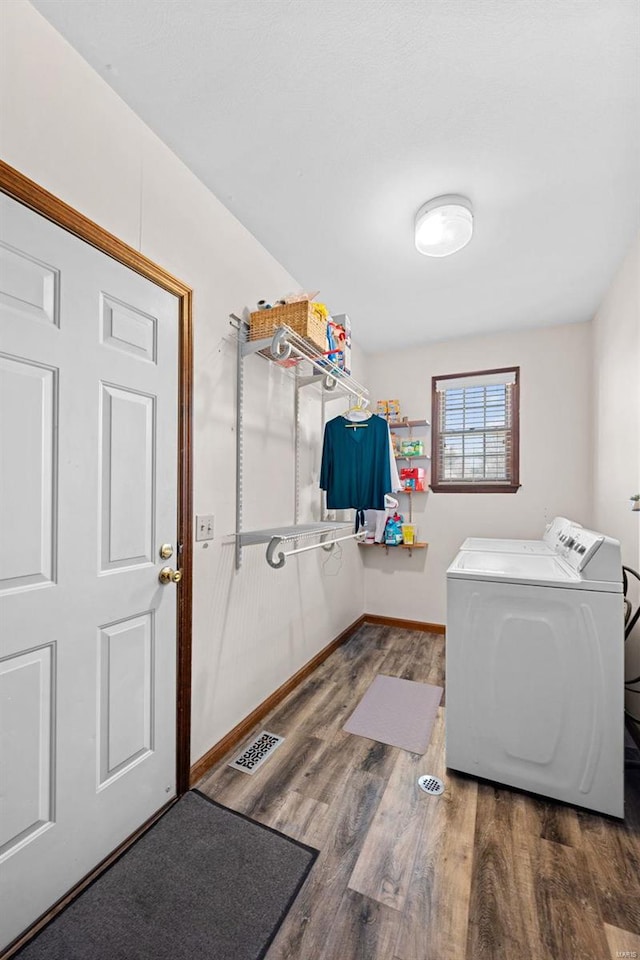 laundry room featuring wood finished floors, visible vents, baseboards, laundry area, and washer and dryer