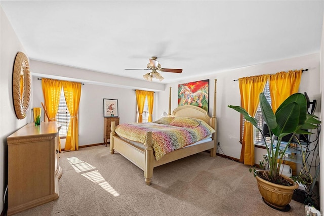 carpeted bedroom featuring a ceiling fan and baseboards