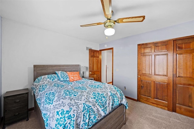 carpeted bedroom with visible vents, a ceiling fan, and baseboards