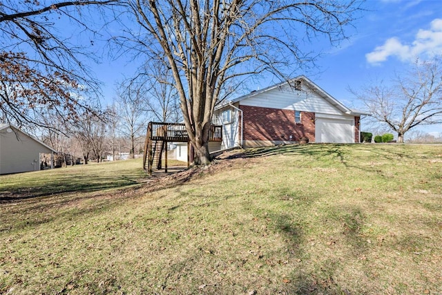 view of yard with a garage, stairs, and a deck