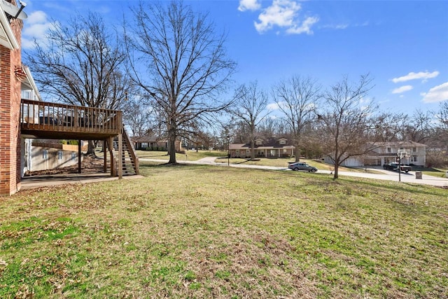 view of yard featuring a wooden deck and stairs