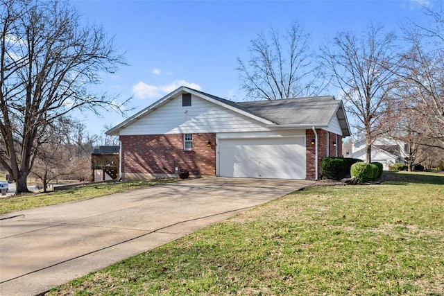 view of side of property featuring brick siding, a yard, driveway, and a garage