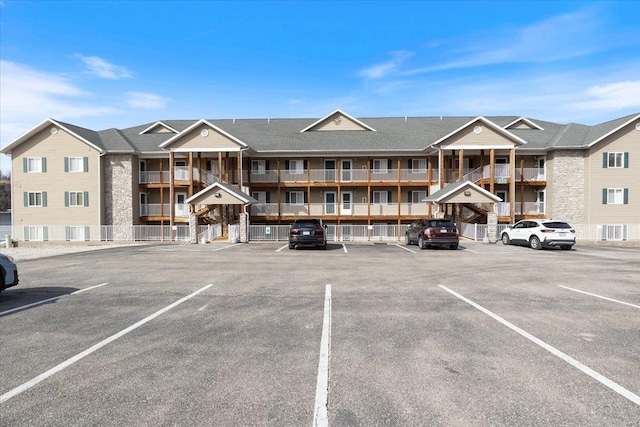 view of building exterior with uncovered parking