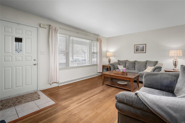 living room with baseboards, light wood-type flooring, and baseboard heating