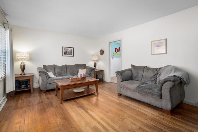 living area with baseboards and hardwood / wood-style floors