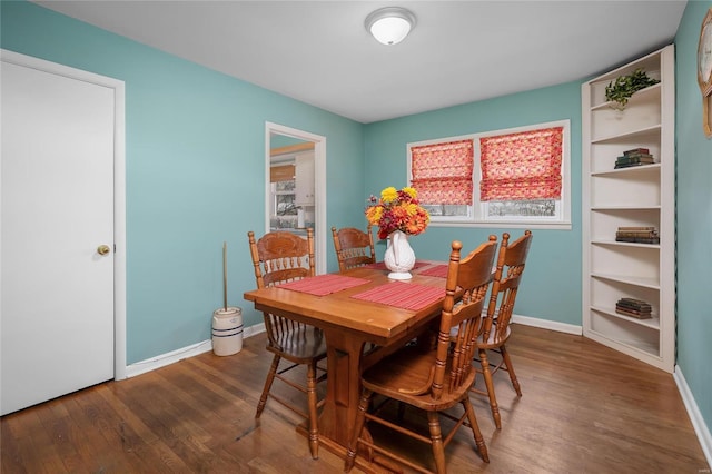 dining space featuring baseboards and wood finished floors