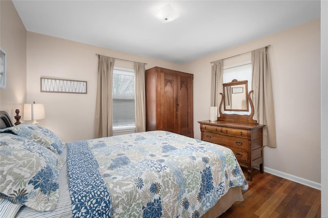 bedroom featuring baseboards and wood finished floors