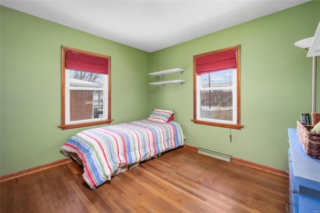 bedroom with baseboards and wood finished floors