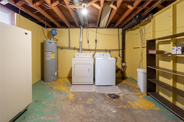 laundry room featuring water heater, laundry area, and washer and clothes dryer