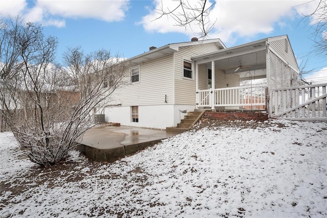 snow covered property featuring a patio area, central air condition unit, and ceiling fan