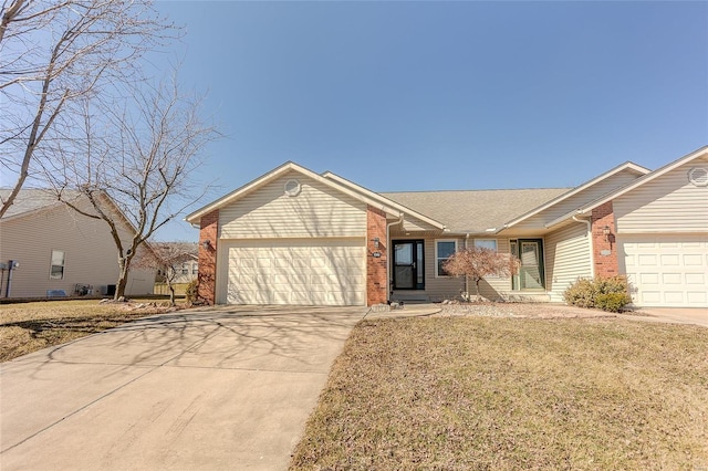 ranch-style home with driveway, an attached garage, a front lawn, and brick siding