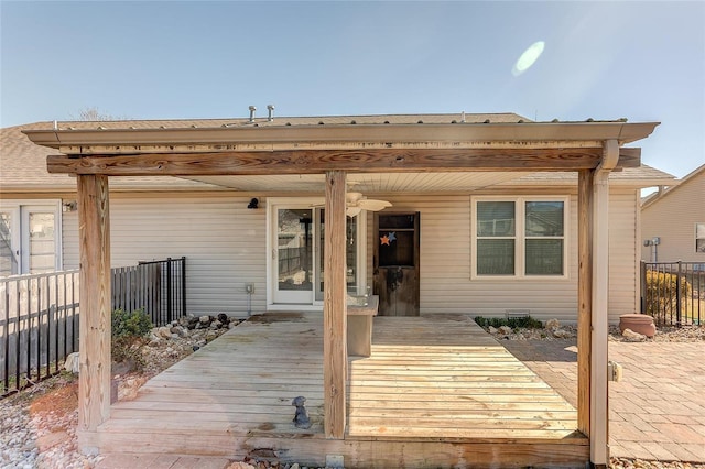 wooden terrace featuring fence and ceiling fan