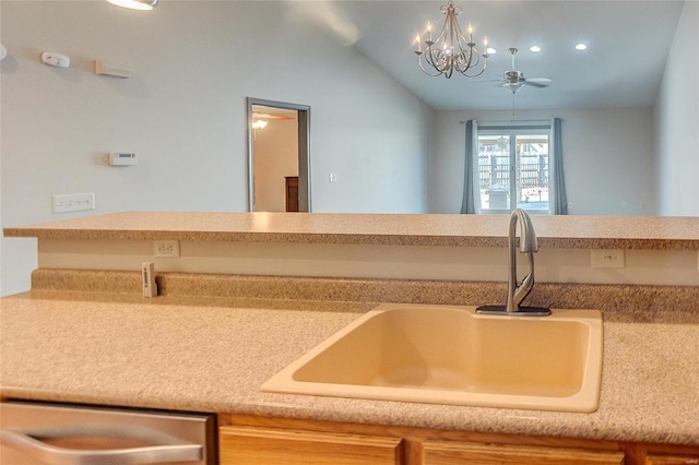 kitchen with vaulted ceiling, light countertops, and a sink