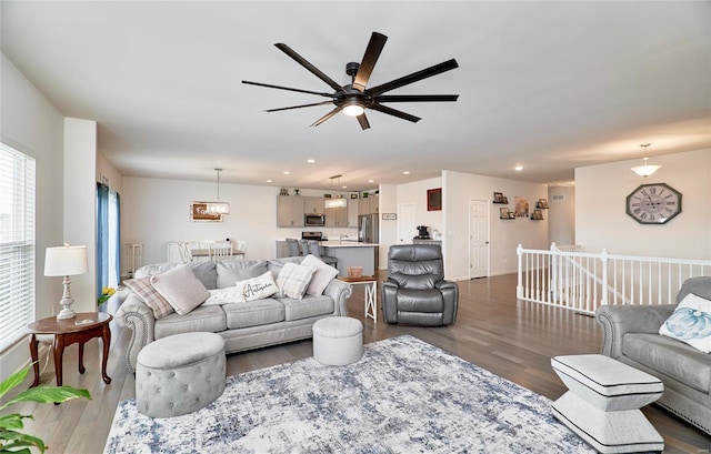 living area featuring recessed lighting, baseboards, and wood finished floors