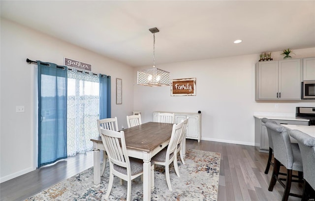 dining area with dark wood-type flooring, recessed lighting, and baseboards