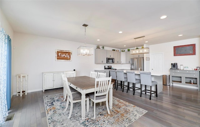 dining space featuring visible vents, dark wood-type flooring, recessed lighting, baseboards, and a chandelier