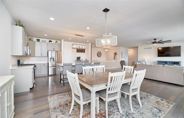 dining area with a ceiling fan, recessed lighting, wood finished floors, and visible vents