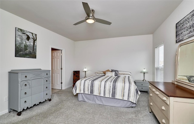 bedroom featuring baseboards, light carpet, and ceiling fan