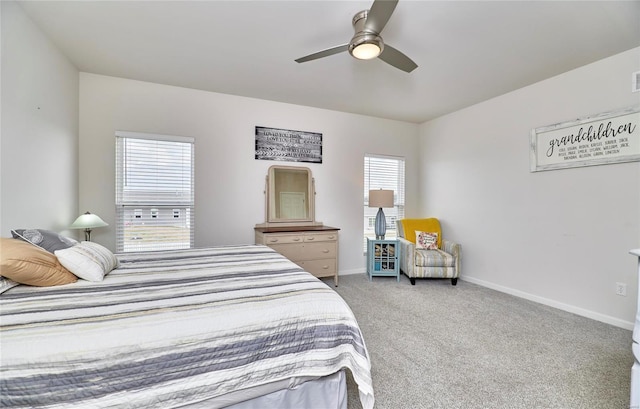 carpeted bedroom with ceiling fan and baseboards