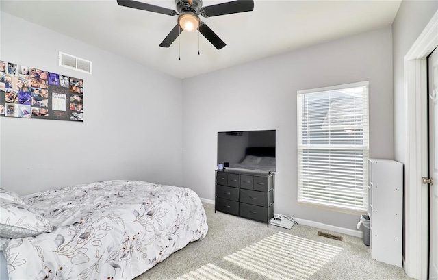 carpeted bedroom featuring visible vents, a ceiling fan, and baseboards