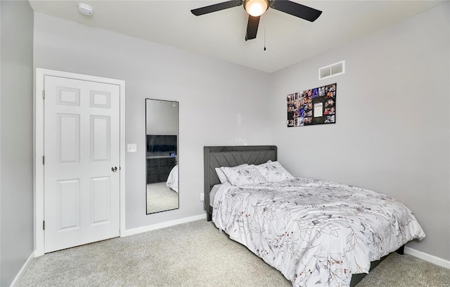 carpeted bedroom featuring visible vents, baseboards, and ceiling fan