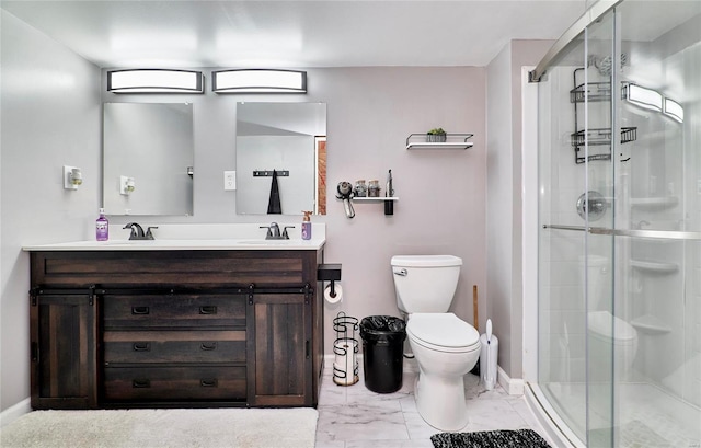 bathroom featuring double vanity, a stall shower, toilet, and a sink