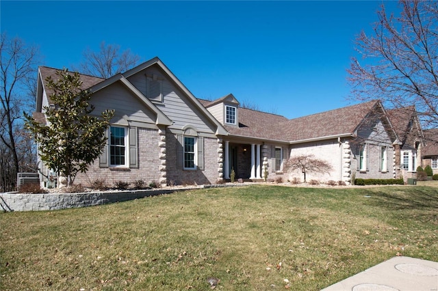 view of front facade featuring a front lawn and brick siding