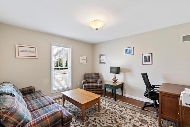 home office featuring visible vents, baseboards, and wood finished floors