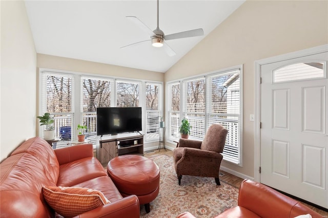 living area featuring ceiling fan, baseboards, lofted ceiling, and wood finished floors