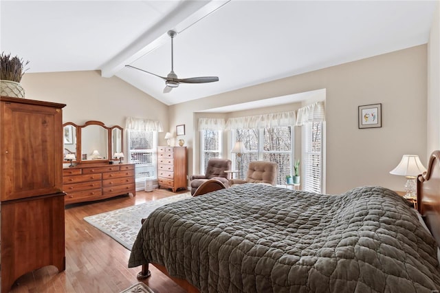 bedroom featuring lofted ceiling with beams, a ceiling fan, and light wood finished floors