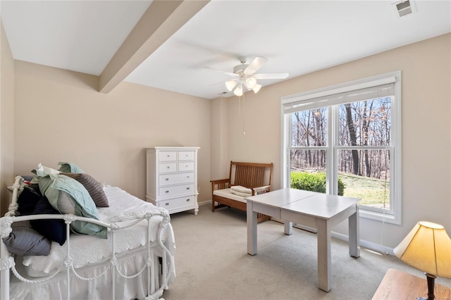 bedroom with light carpet, visible vents, multiple windows, and baseboards