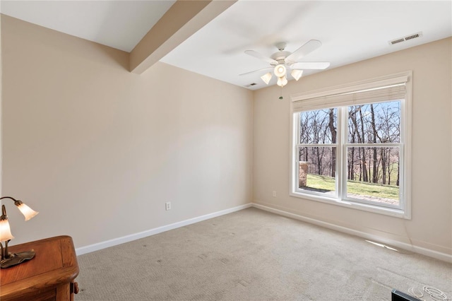 unfurnished room with a ceiling fan, light colored carpet, visible vents, and baseboards