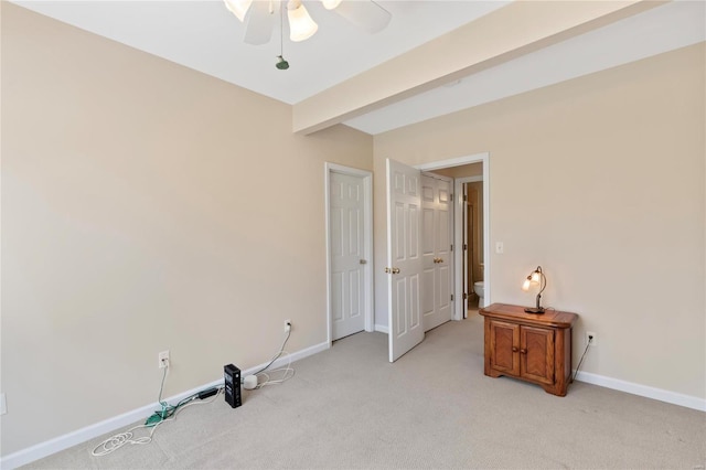 bedroom featuring beamed ceiling, baseboards, light colored carpet, and ceiling fan