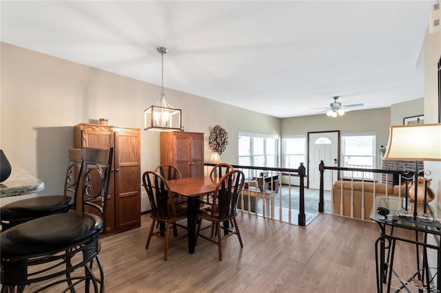 dining area with wood finished floors, visible vents, and ceiling fan