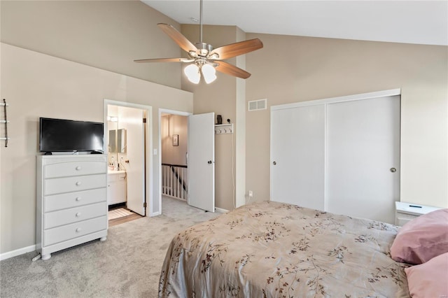 bedroom featuring visible vents, connected bathroom, baseboards, light colored carpet, and a closet