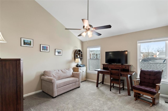 interior space with lofted ceiling, light colored carpet, baseboards, and ceiling fan