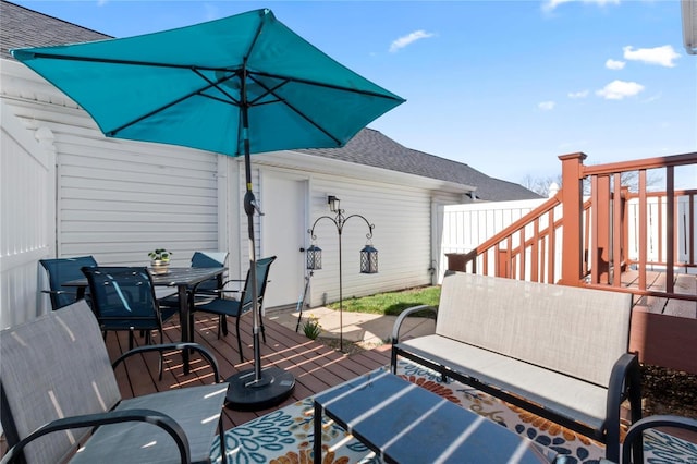 view of patio / terrace featuring outdoor dining space, stairs, and a deck