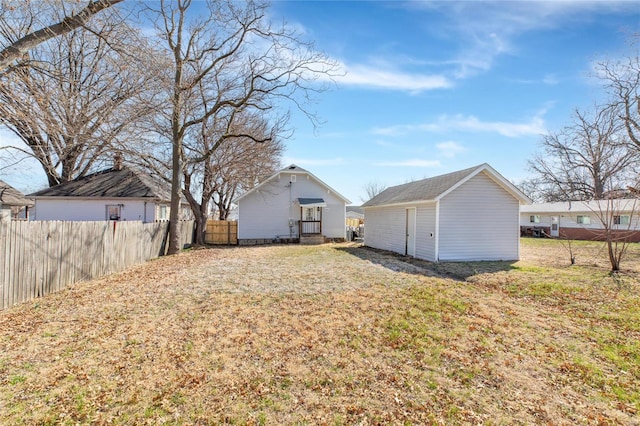 view of yard featuring an outbuilding and fence